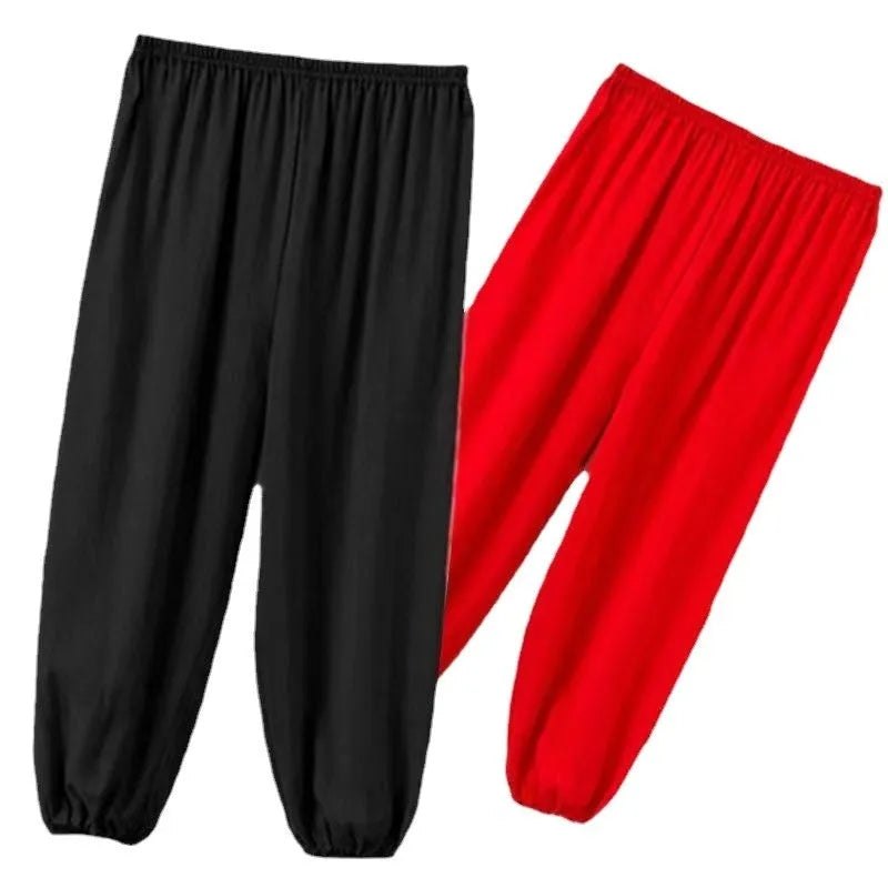 Child wearing black high elasticity Sanda practice pants made from spandex Lycra for martial arts training.