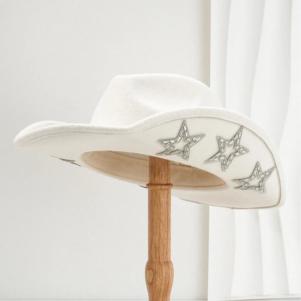 Beige polyester western denim top hat with a conical crown and a silver hexagonal star decoration on the front.
