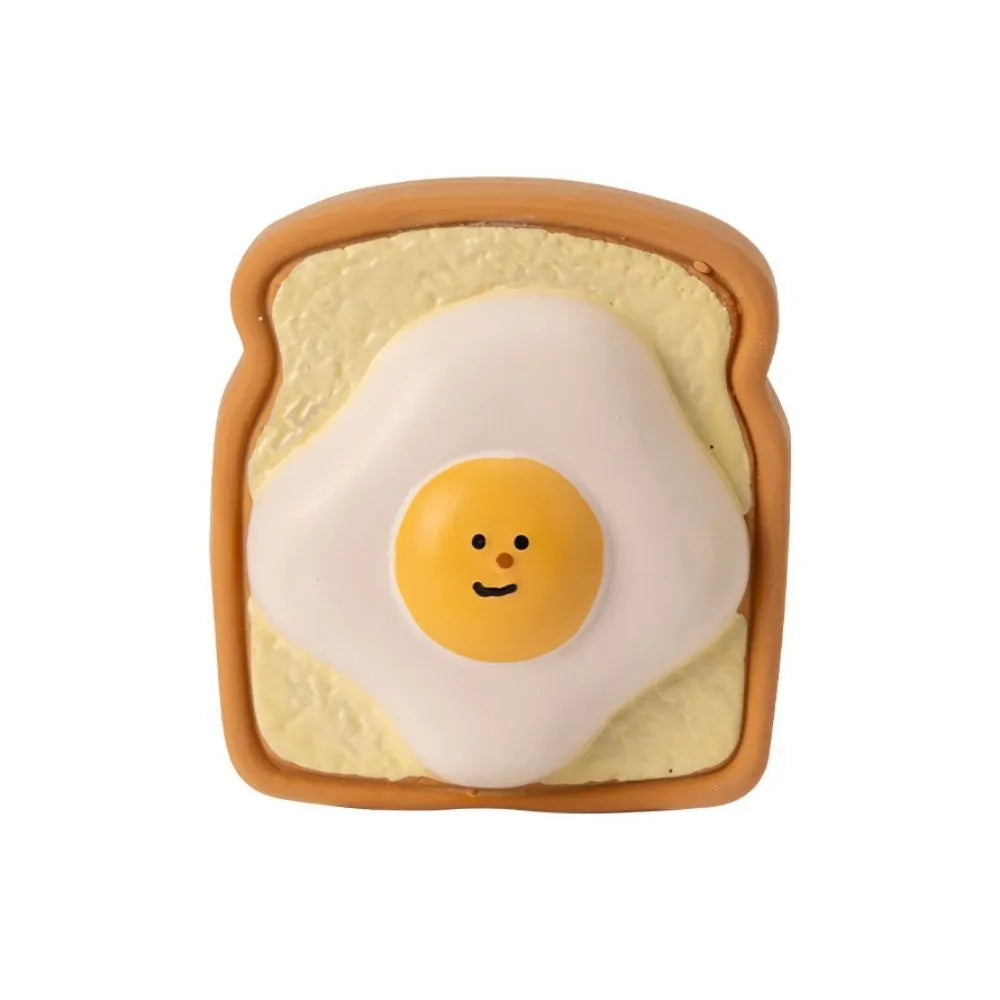 Yellow and green cartoon bread shaped latex dog squeaky chew toy on a white background.