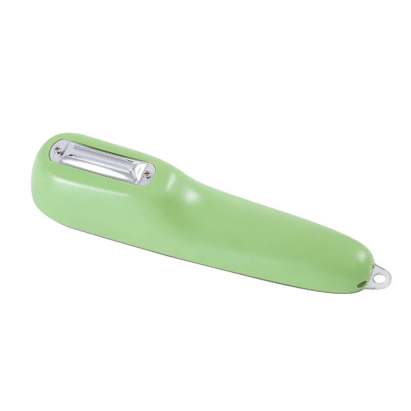 Dark green vegetable peeler with a storage tube and a stainless steel blade on a kitchen worktop.
