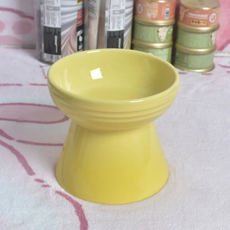 Black chin-high foot ceramic pet bowl for dogs and cats on a flat surface.
