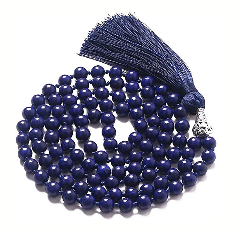 Long geometric agate and gemstone tassel necklace with blue, purple, and multi-coloured beads on a black background.