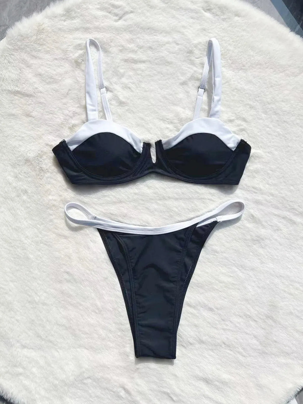 Black women's low-waist bikini swimsuit with stitch detailing and split briefs.
