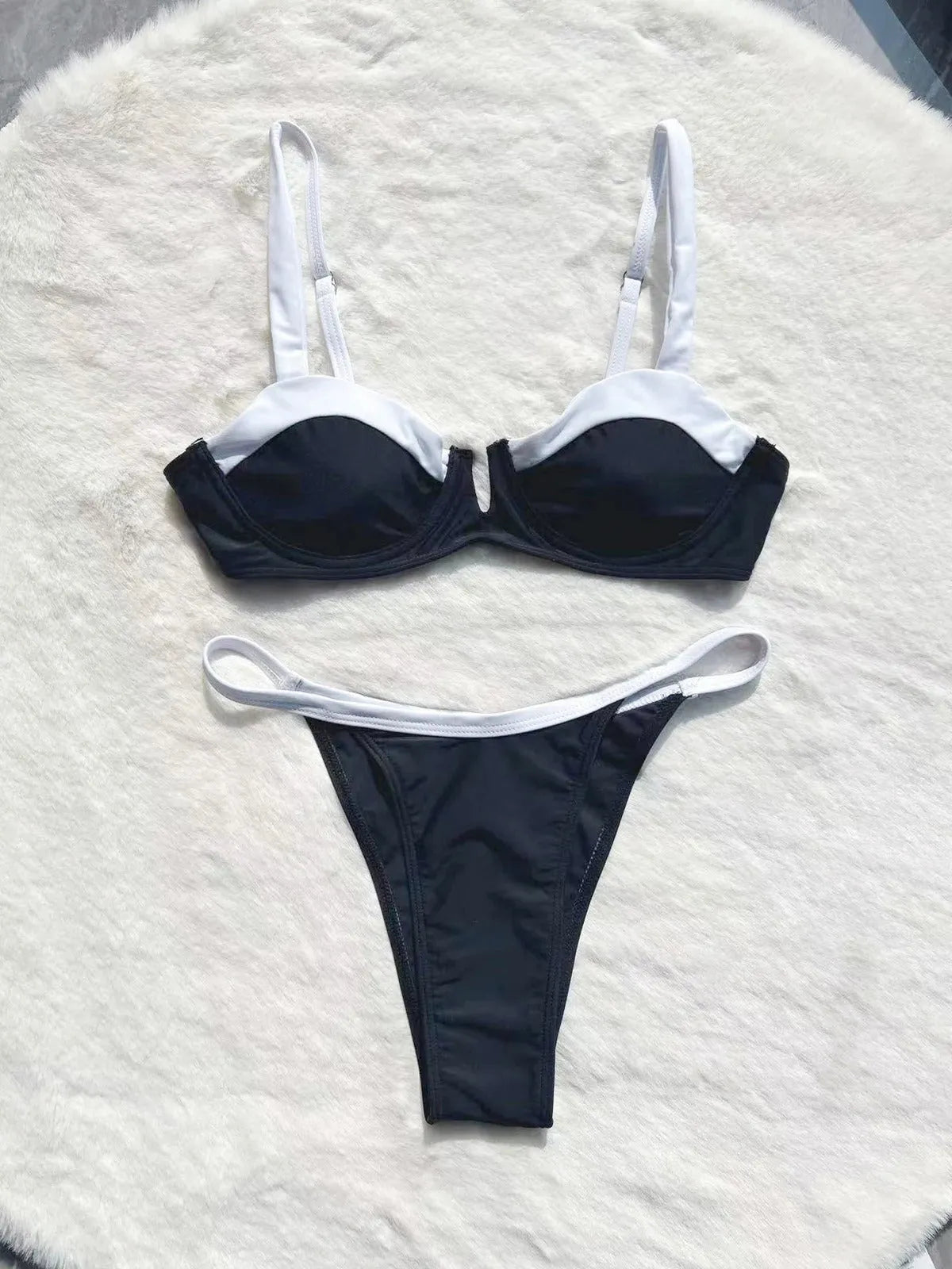 Black women's low-waist bikini swimsuit with stitch detailing and split briefs.