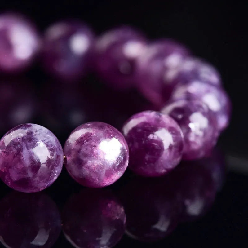 Purple geometric crystal bracelet with polished beads, shown in different size options.