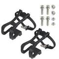 Pair of plastic spinning pedal foot holder covers with lashing straps and metal bolts on a black background