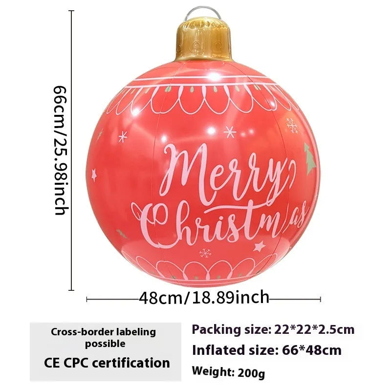 Large red and white inflatable Christmas ball with flashing lights in a garden setting.
