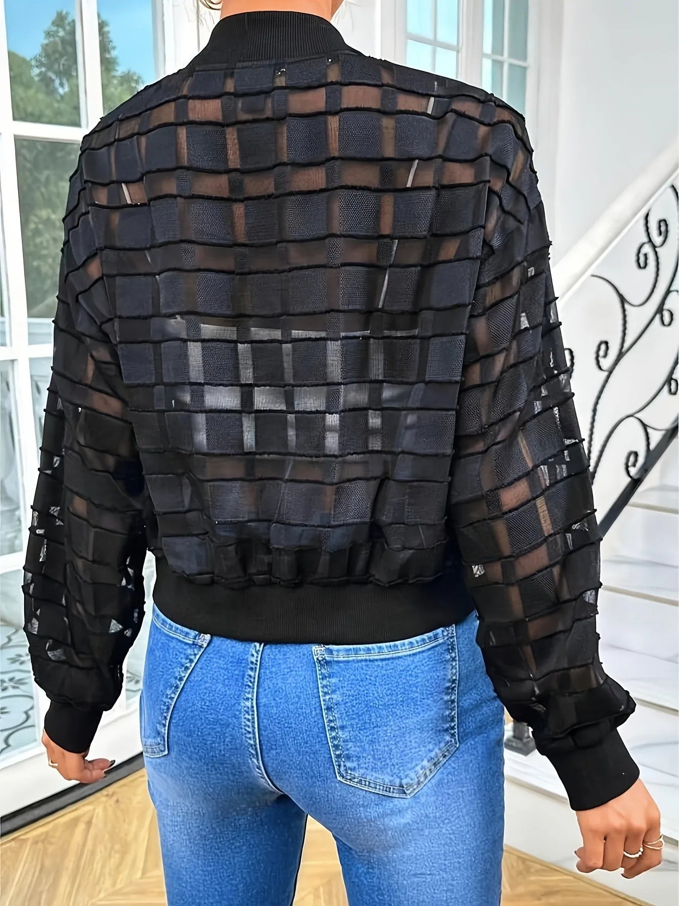 Black women's casual jacket with geometric pattern and semi-transparent thread detail, zip front.