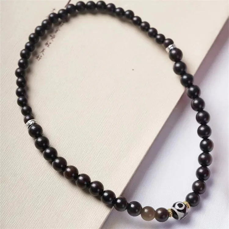 Ebony wood bracelet with 8mm beads showing two circles pattern, unisex design