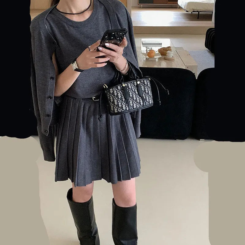 Grey art retro women's knitted cardigan and pleated vest skirt set with a waist belt.