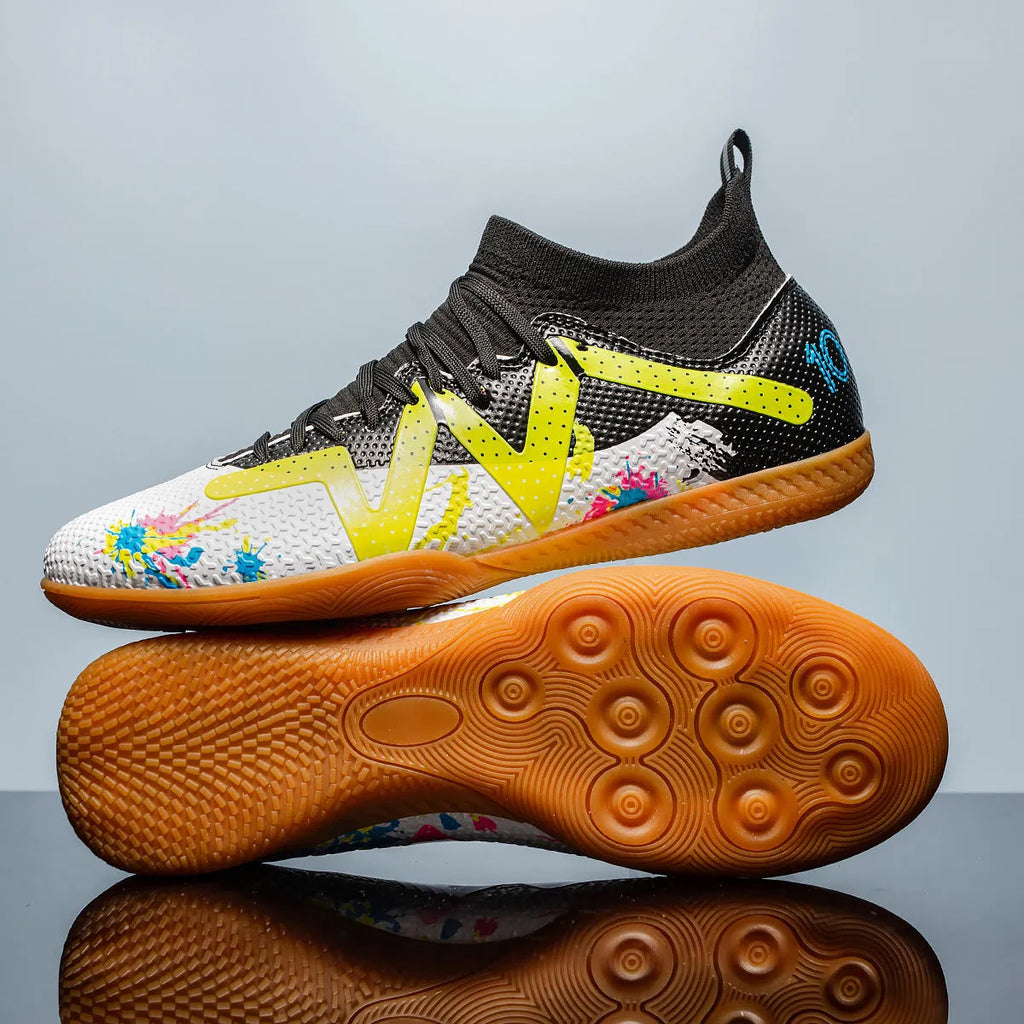 Adult low-top soccer shoes in black and yellow, showing studded rubber sole and printed PVC upper.