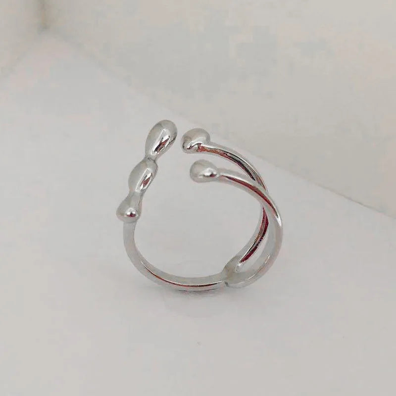 Adjustable open ring for women in brass with circular sphere design, gold or silver finish
