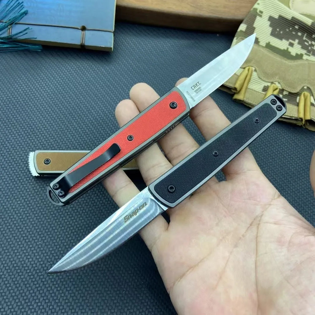 Closed and open views of a folding fruit knife with stainless steel blade in black, brown, or red handle options.