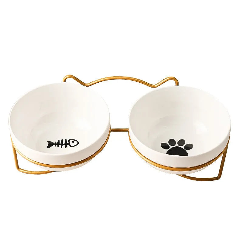 White ceramic pet bowl with cat footprints design in a black iron frame.