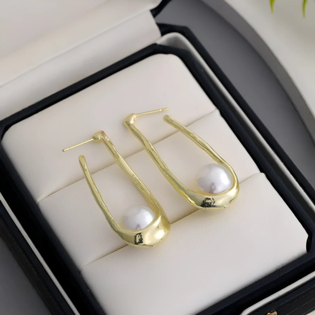 Gold-tone hook earrings with an irregular natural pearl in a vintage European style