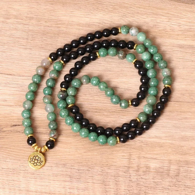 Green and black elastic beaded long bracelet made from alloy material.