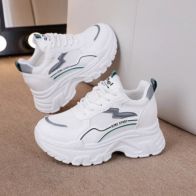 Women's white and beige height increasing dad shoes with cross straps and rubber sole.