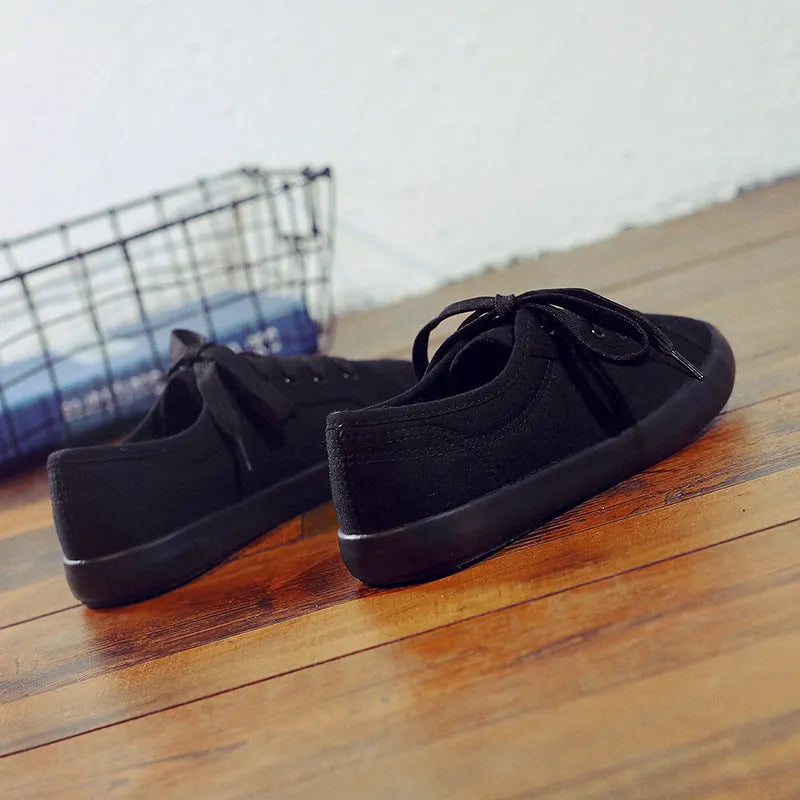 All black Korean style canvas flat work shoes for women with front lace-up and rubber sole