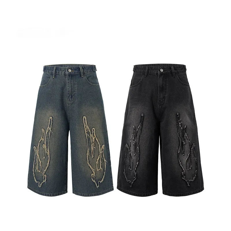 Men's black denim cropped shorts with flame embroidery patch design on leg