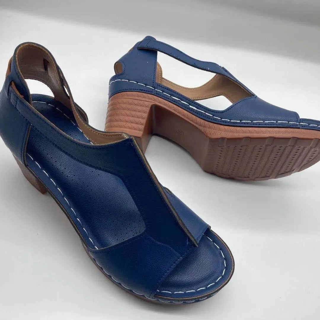 Women's white peep toe wedge sandals with a buckle strap on the ankle.