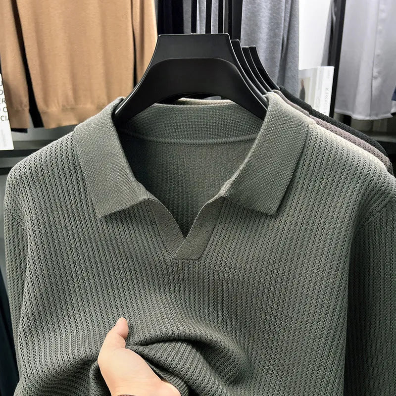 Men's loose green pullover sweater on a hanger, casual autumn wear