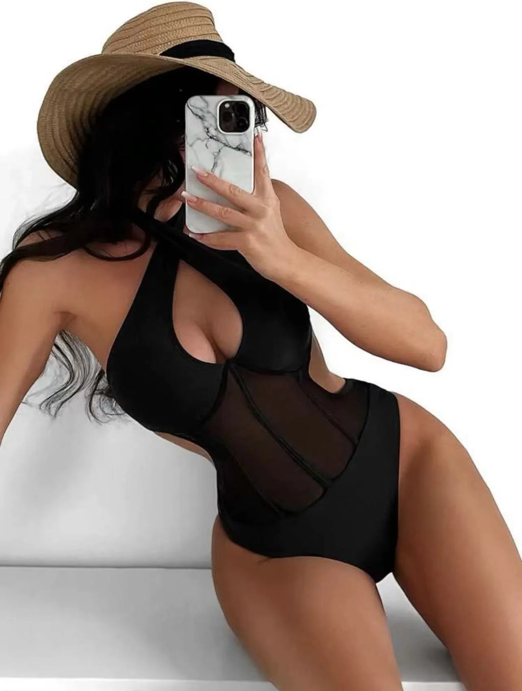 A black ladies one-piece swimsuit bikini made from nylon and spandex fabric on a neutral background.