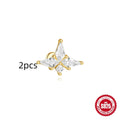 Geometric kite-shaped sterling silver stud earrings with rhinestones and a gold chain tassel.