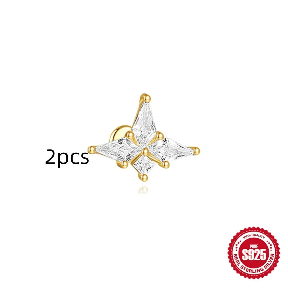 Geometric kite-shaped sterling silver stud earrings with rhinestones and a gold chain tassel.