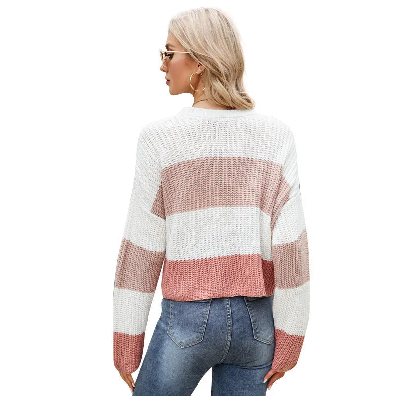 Women's short striped loose pullover sweater in acrylic fabric on a hanger.