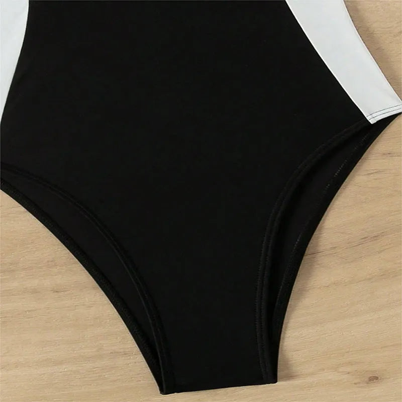 Black and white women's one-piece swimsuit with spaghetti straps and a slimming silhouette