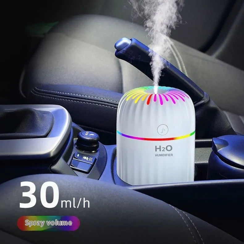 Mini green car-shaped USB aromatherapy humidifier with compact plastic housing on a white background.