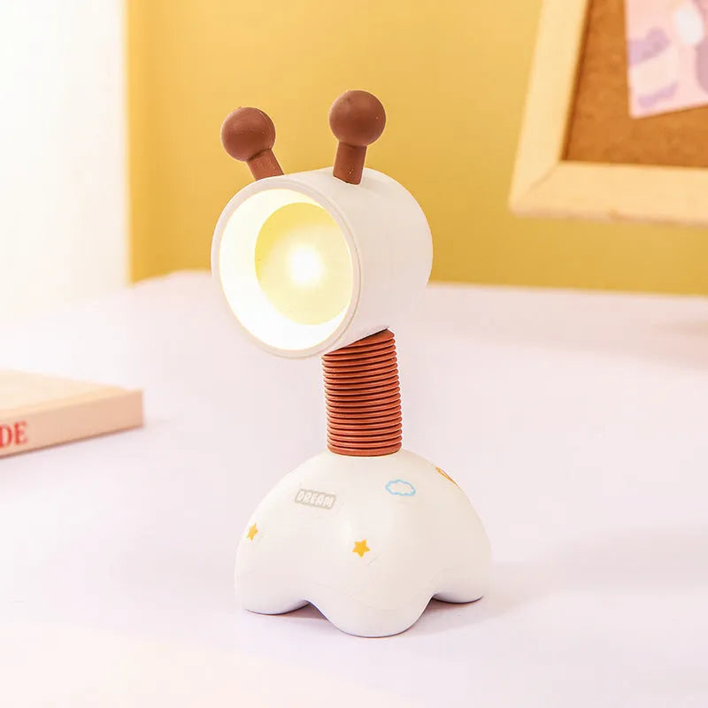 DIY cartoon animal small night lamp with magnetic base in assorted colours on a desk.