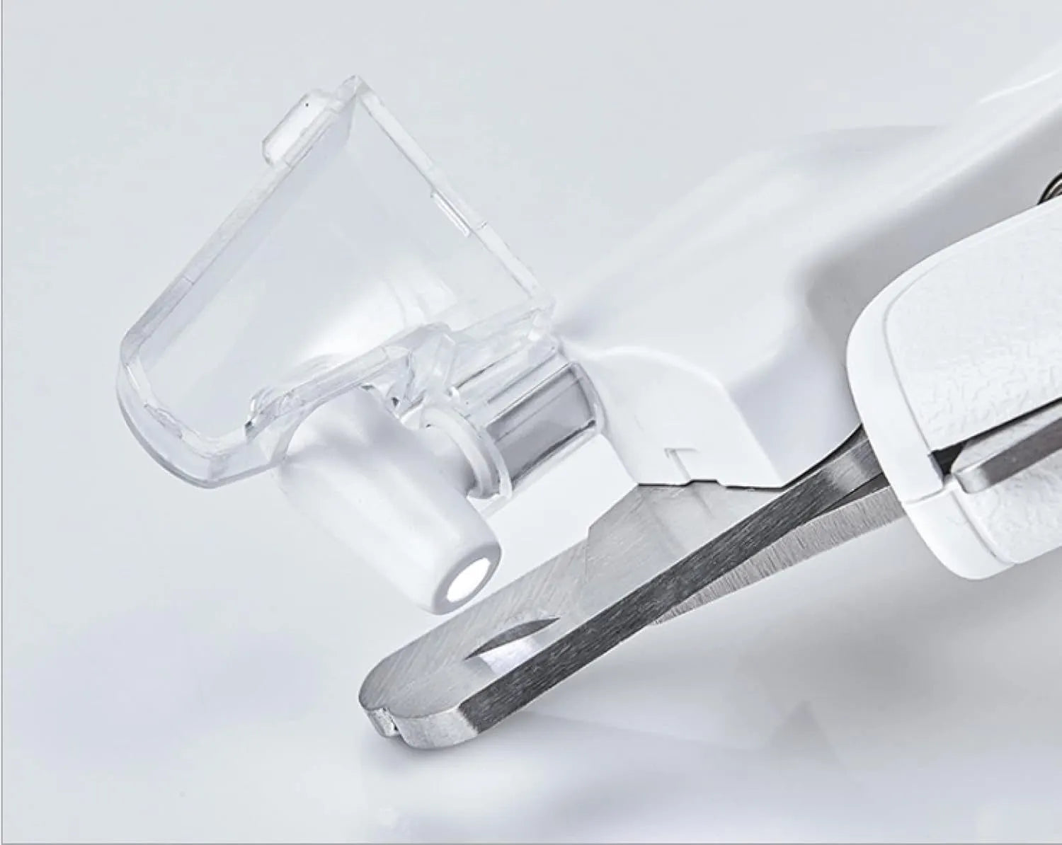 White LED pet nail clipper with a triangular blade, anti-splash guard, and leatherette handle.
