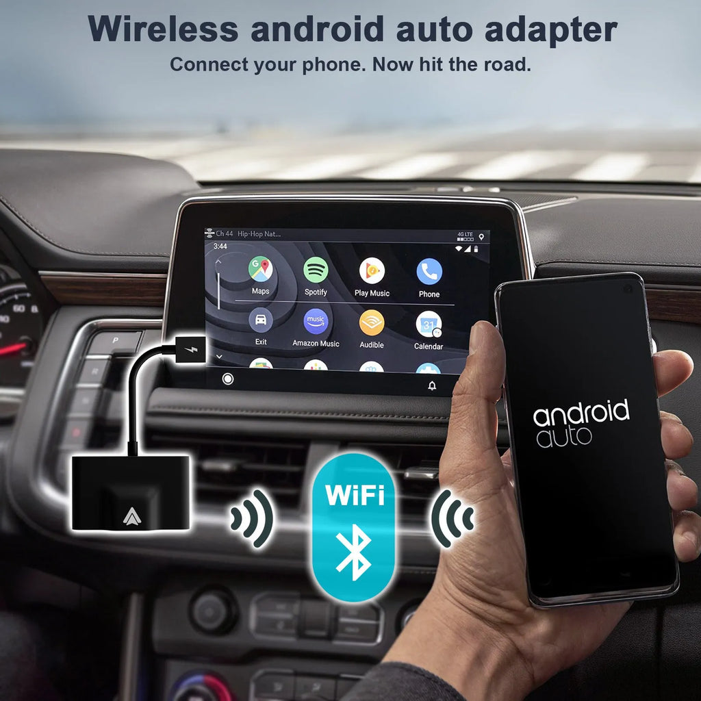 Black wireless Android Auto car adaptor connected to a car USB port with a smartphone displaying a navigation app wirelessly.