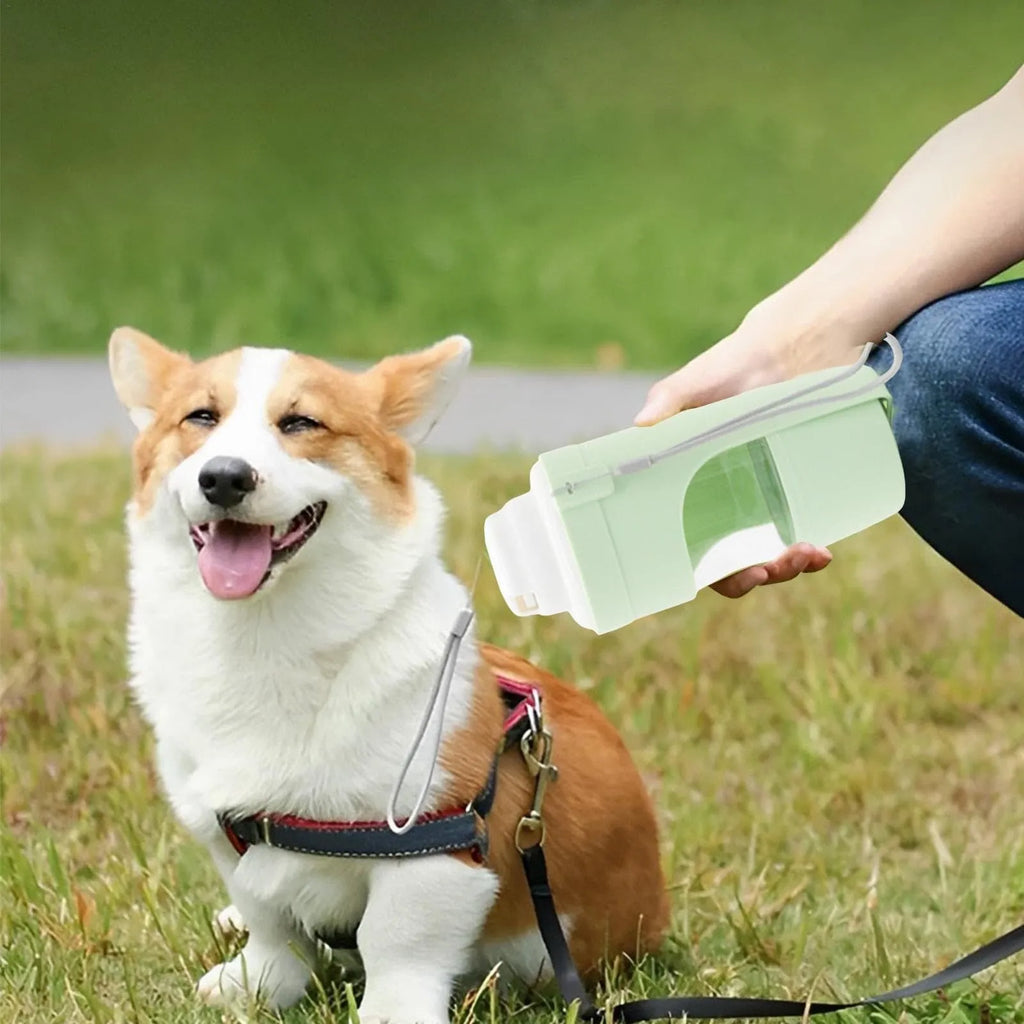 Green 2-in-1 travel dog water bottle and feeder with lanyard, folded to 20cm.