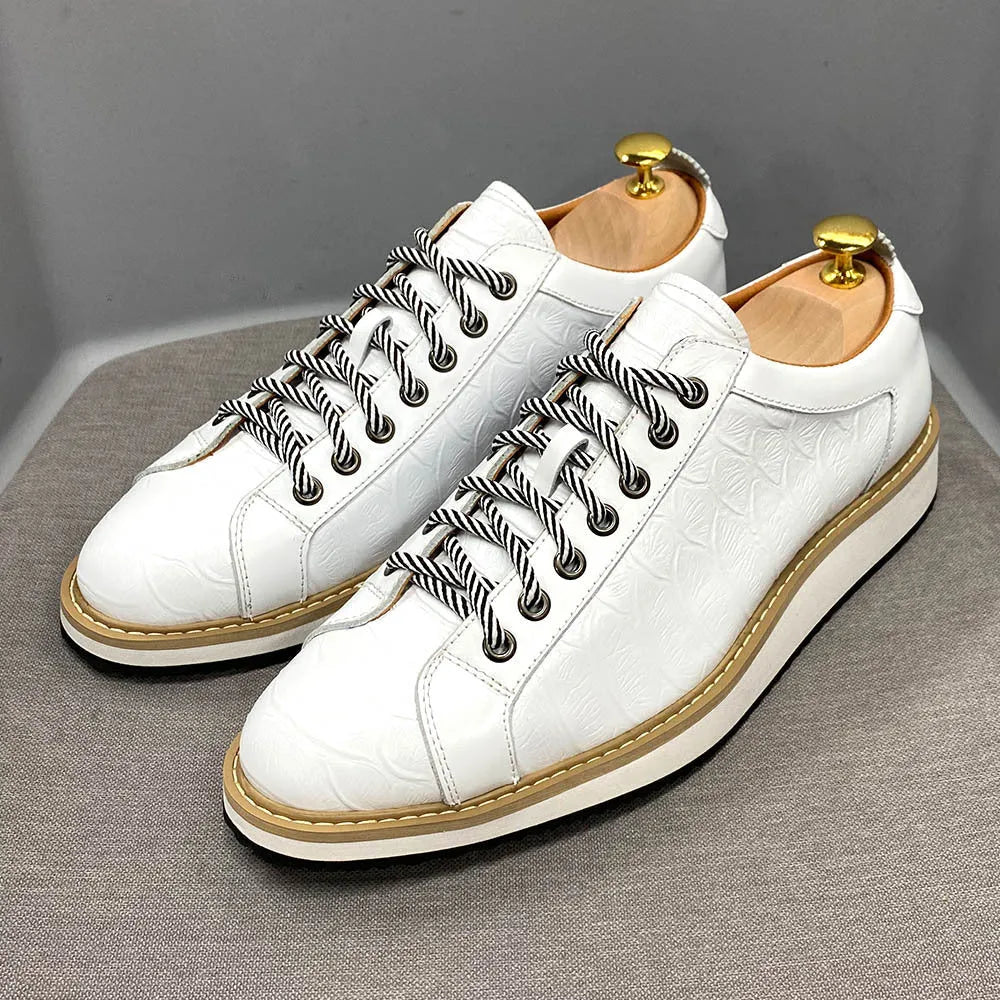 Low-top handmade men's shoes with an embossed pattern, shown in a choice of colours including black and green.