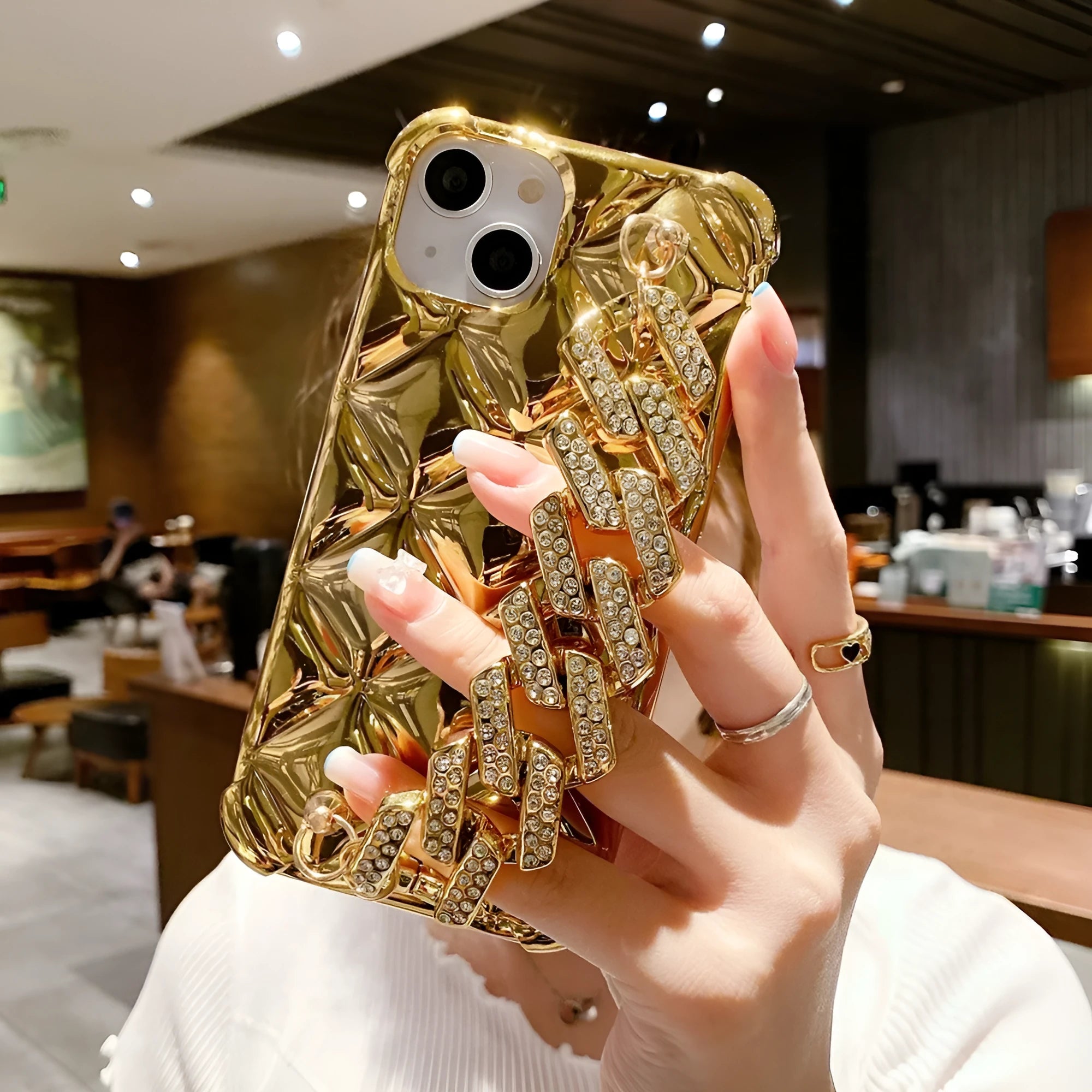 Luxury diamond bracelet design iPhone case in gold and silver colours with chain detail.
