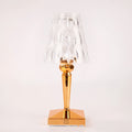 Rose gold portable touch control night light with dimming settings on a surface.