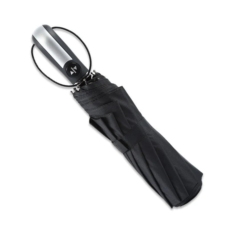 Black triple folding automatic business umbrella with 10 ribs and a rubber handle, shown open.