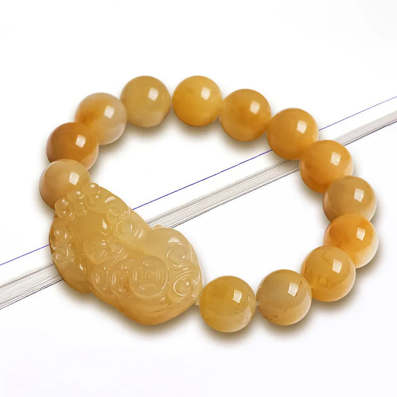 Personalised carved Golden Thread Jade bracelet showing bead detail and size comparison.