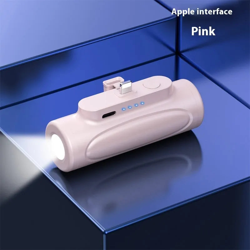 Black and pink creative power bank with integrated LED flashlight, showing Type-C and Apple port options.
