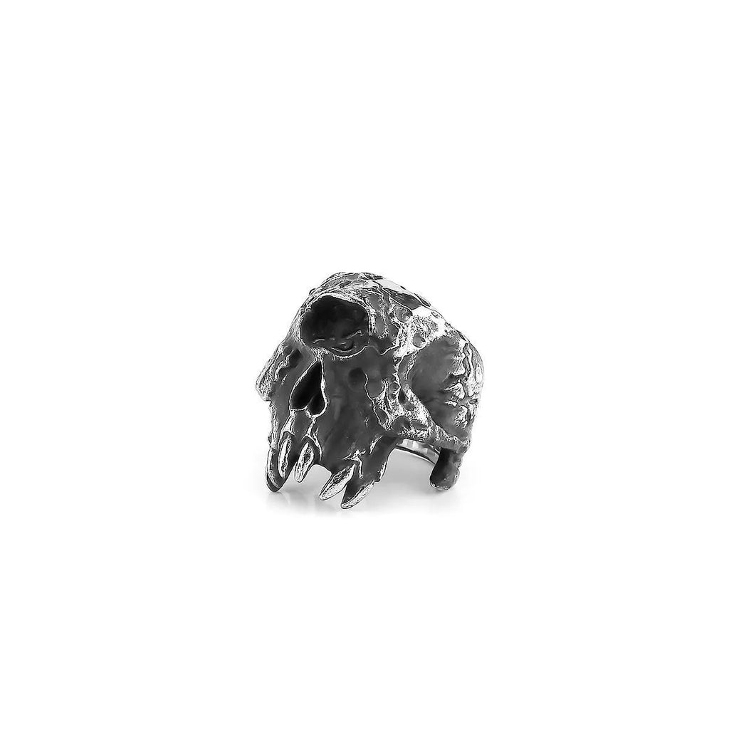 Alloy one-eyed skull ring in retro punk style on a black background.