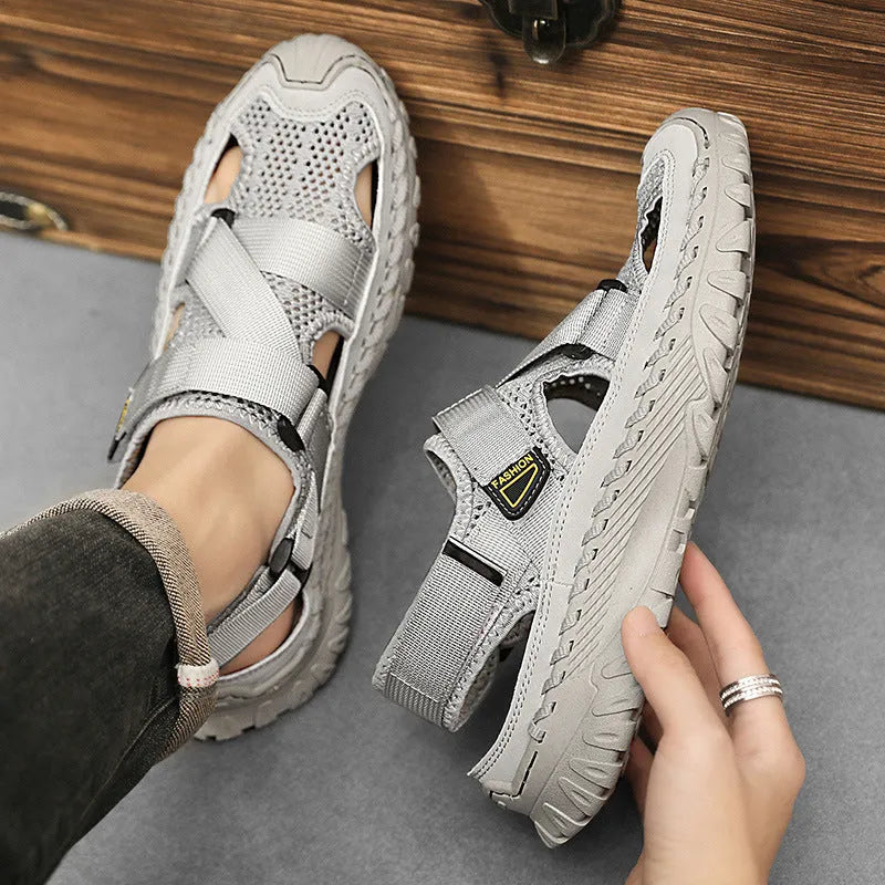 Men's grey genuine leather sandals with mesh lining and an elastic band on a rubber sole.