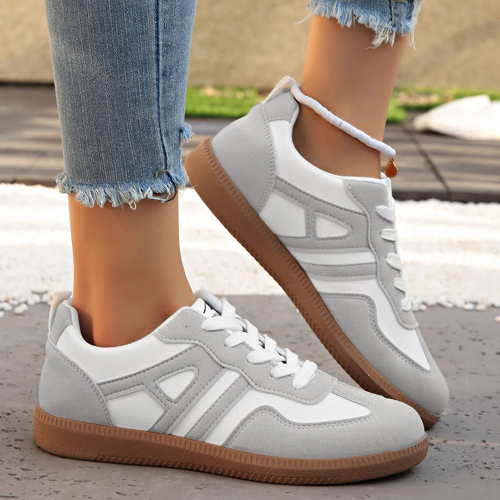 Women's retro grey jogging shoes with colour matching details, lace-up front, and a low platform heel.