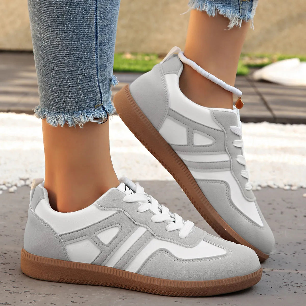 Women's retro grey jogging shoes with colour matching details, lace-up front, and a low platform heel.