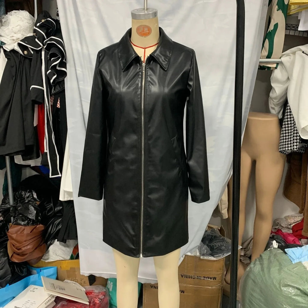 Black polyester women's leather jacket with long sleeves on a hanger.