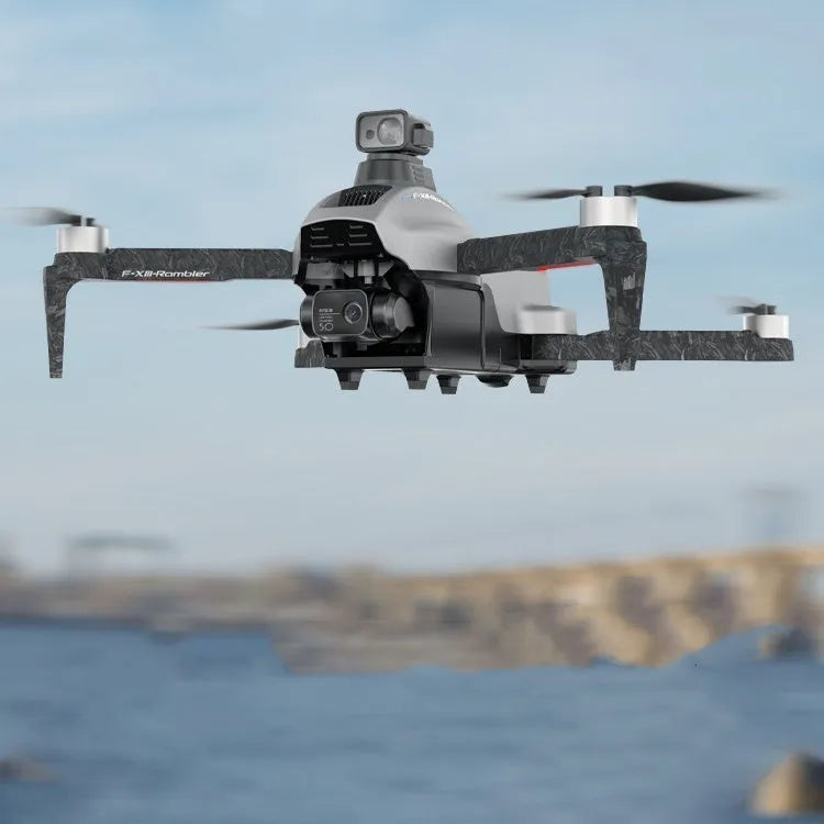 White folding quadcopter drone with camera, shown collapsed next to its remote control and shoulder bag.