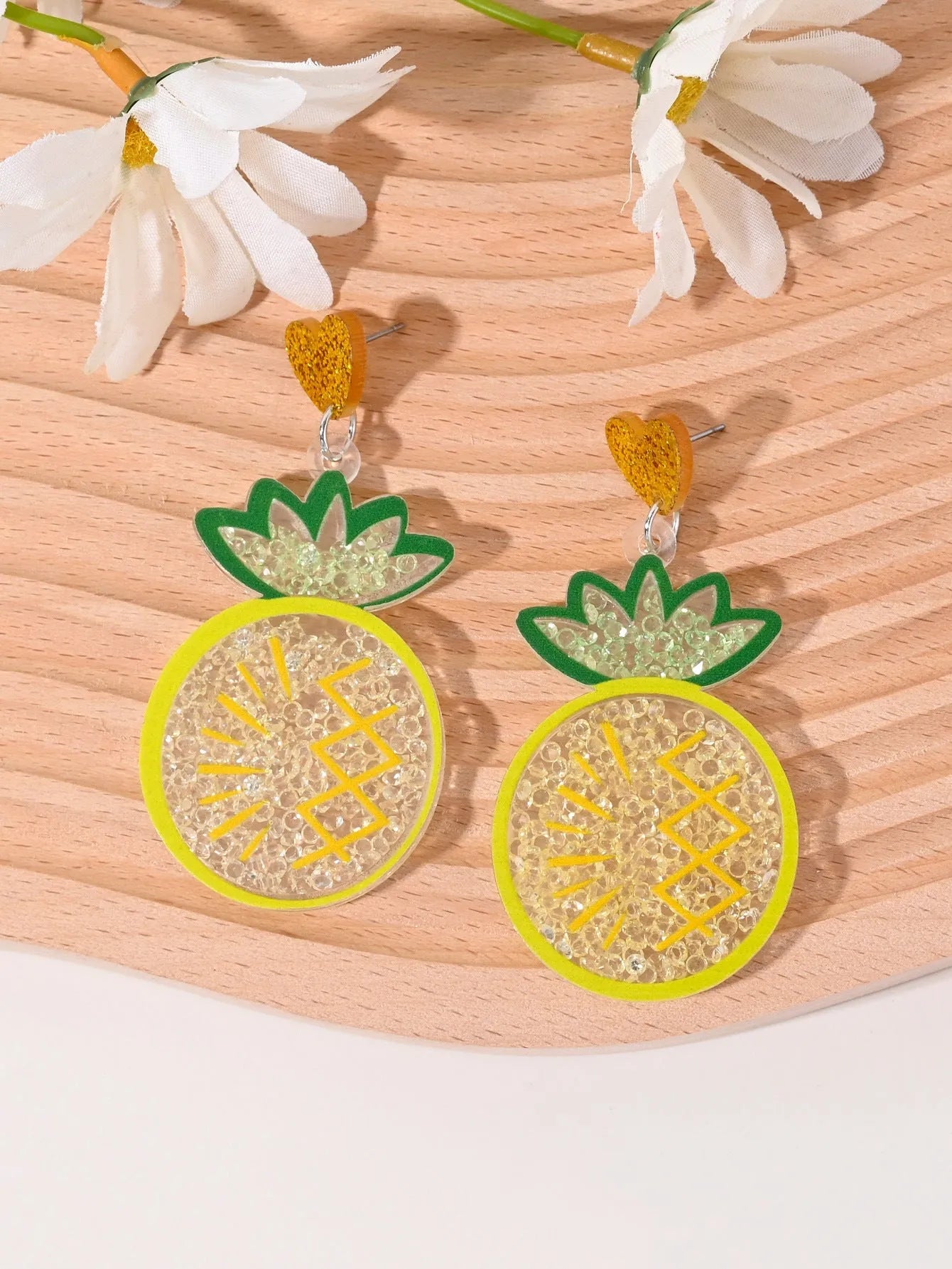 Colourful acrylic earrings with fruit and dessert designs including cherry, strawberry and watermelon shapes