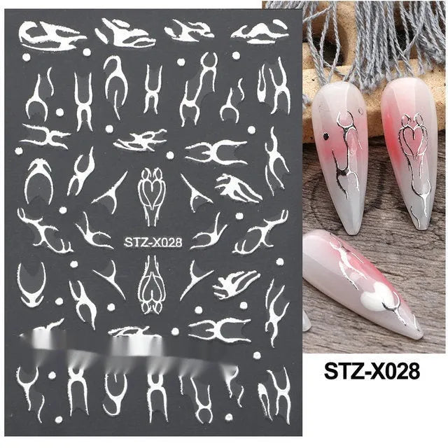 Pack of black and silver strip nail art stickers with cartoon and love pattern designs.