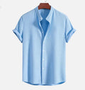 Man wearing a loose-fit short sleeve casual shirt in a solid colour, available in multiple sizes.